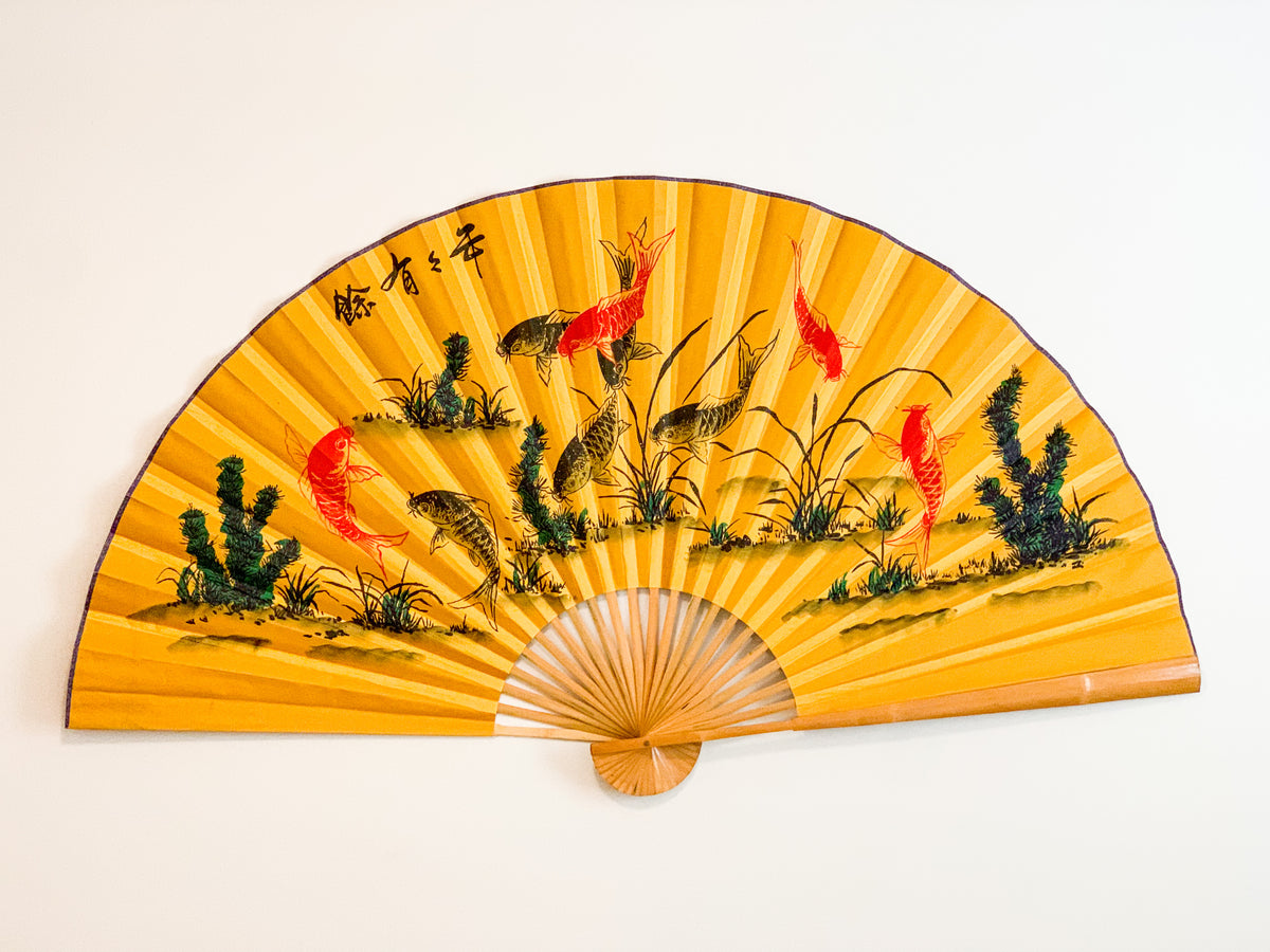 63-INCH EXTRA LARGE DECORATIVE WALL FAN — NINE KOI FISH OF ABUNDANCE ON WARM GOLDEN YELLOW BACKGROUND