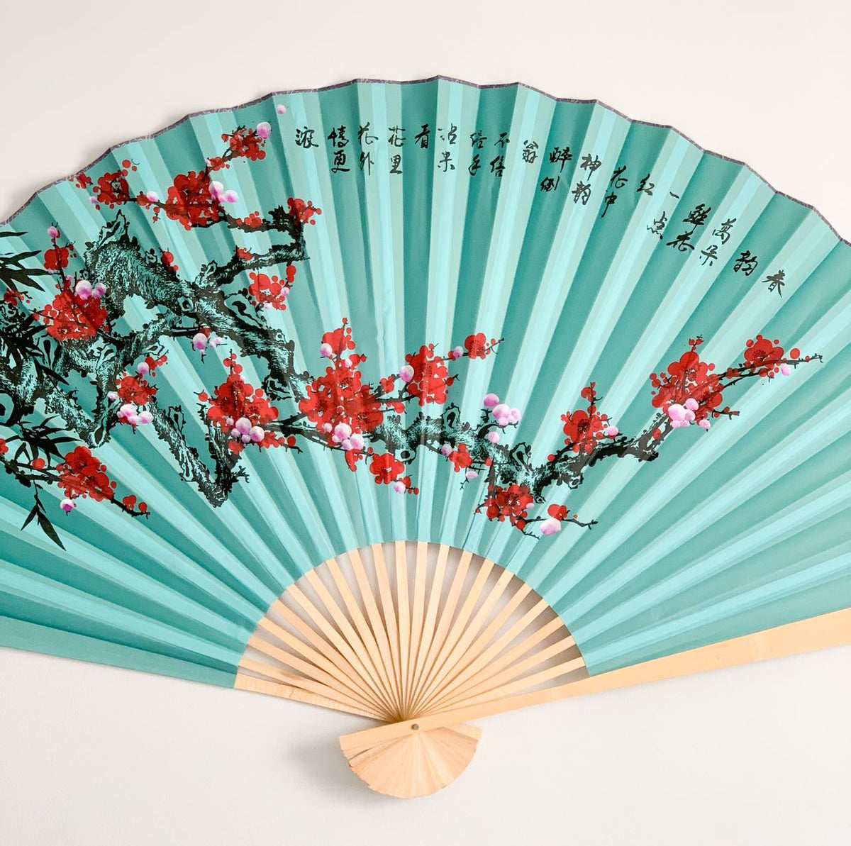 63-INCH EXTRA LARGE DECORATIVE WALL FAN — VIBRANT WINTER PLUM BLOSSOMS & INK BAMBOO ON REGAL TEAL BLUE CANVAS